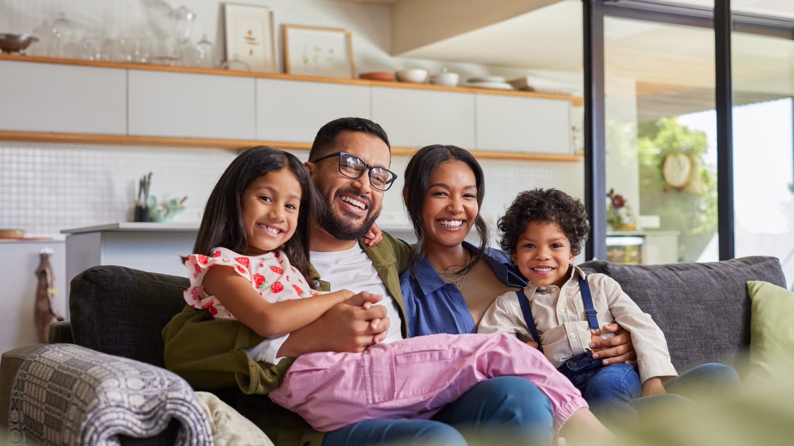 Happy family relaxing in a comfortably cooled home
