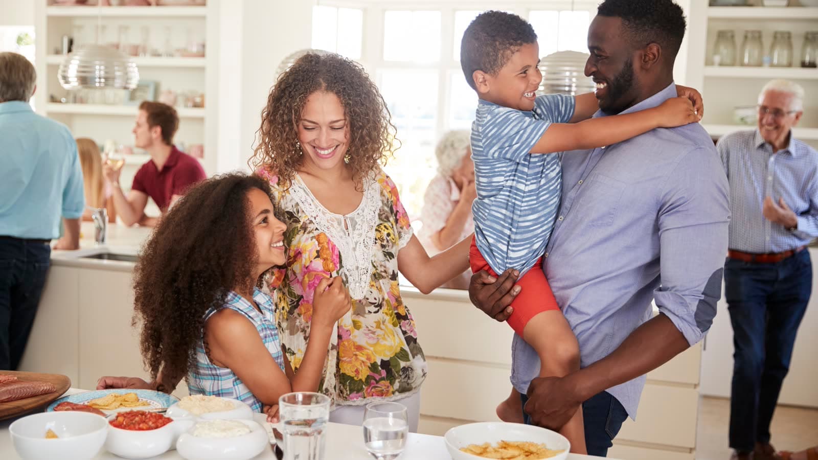 Family gathered in a bright modern kitchen