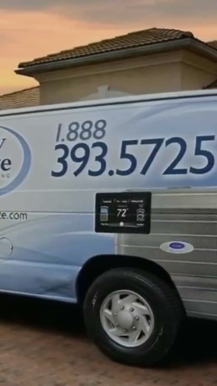 Quality Breeze service van in a South Florida driveway at sunset