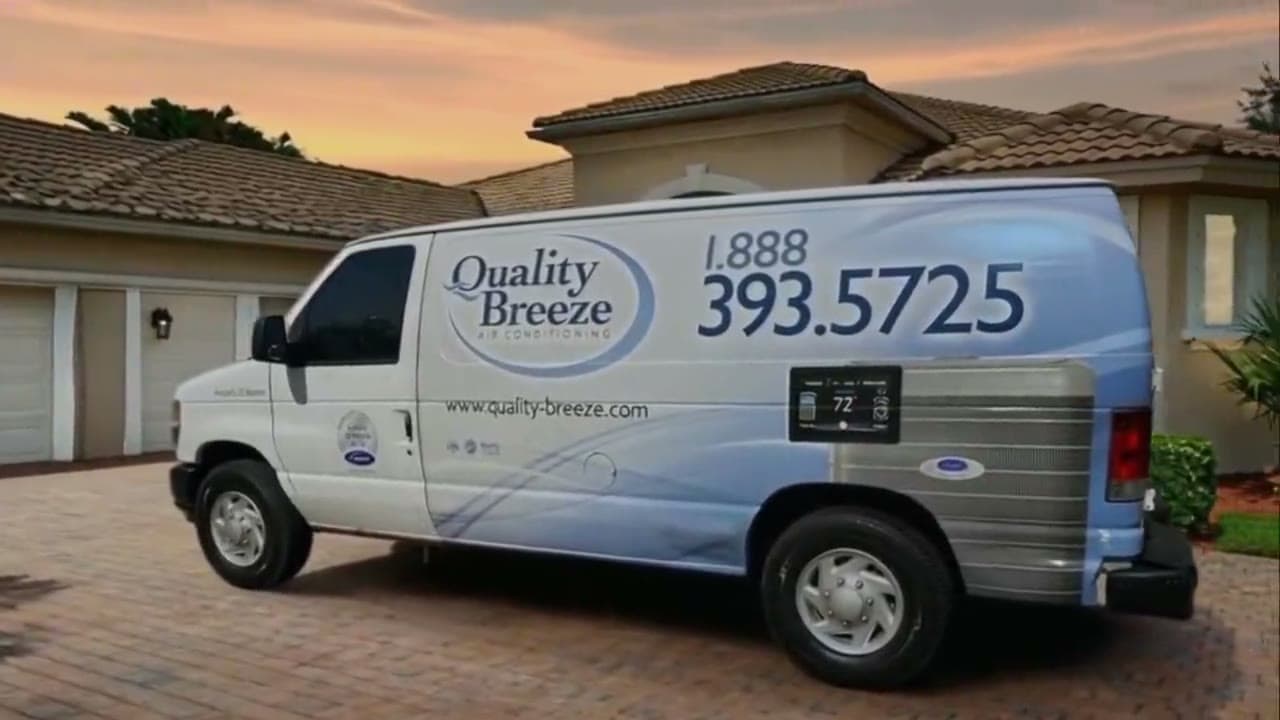 Quality Breeze service van in a South Florida driveway at sunset